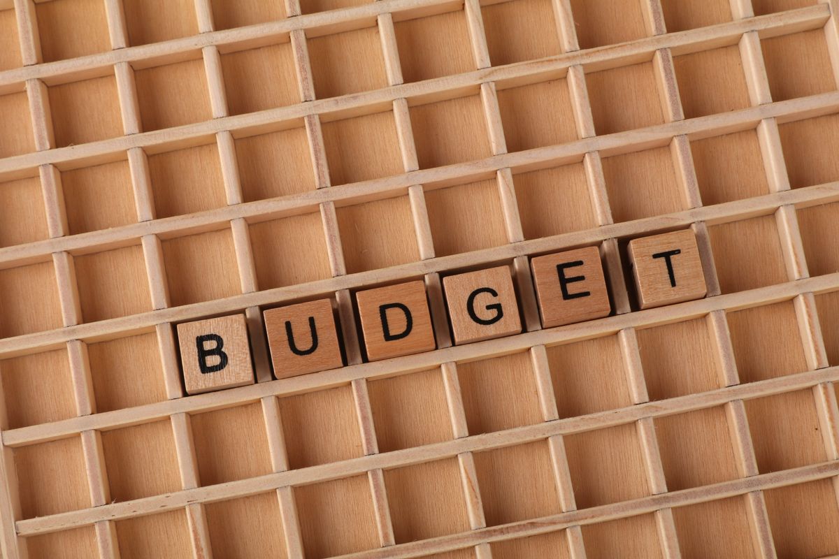 Wooden tiles spelling the word BUDGET representing project cost control and financial management.
