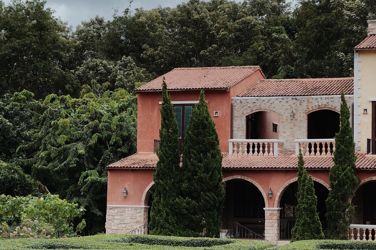 Mediterranean style villa exterior with terracotta walls and arched balconies