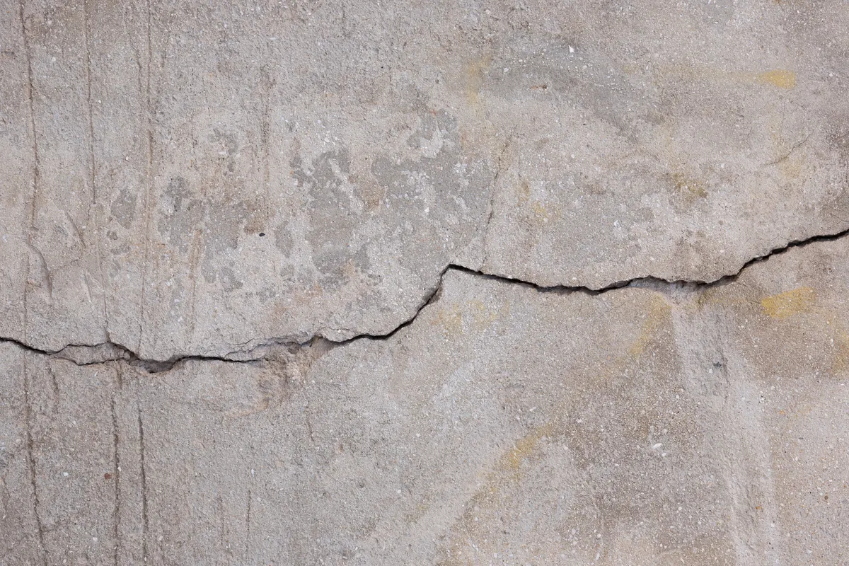 Visible crack in concrete wall illustrating structural risks of unsupervised construction