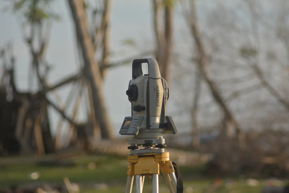 Geodetic total station mounted on a tripod for site analysis and land surveying